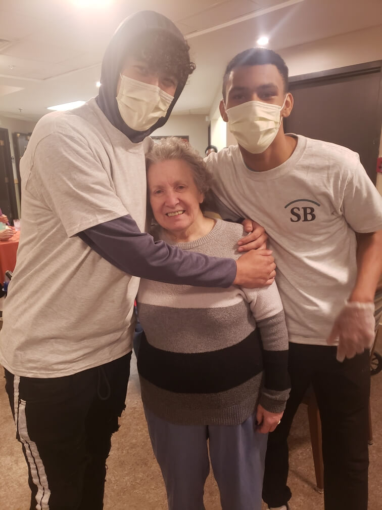 Nursing Home Staff Hugging Resident with masks