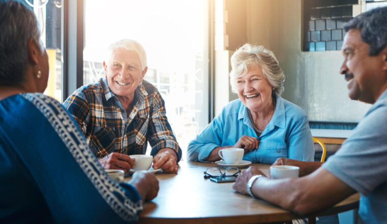 Senior, people and group relax on holiday at cafe on vacation in retirement