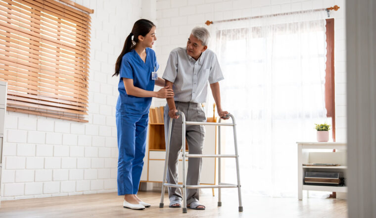 senior elderly man patient doing physical therapy with caregiver