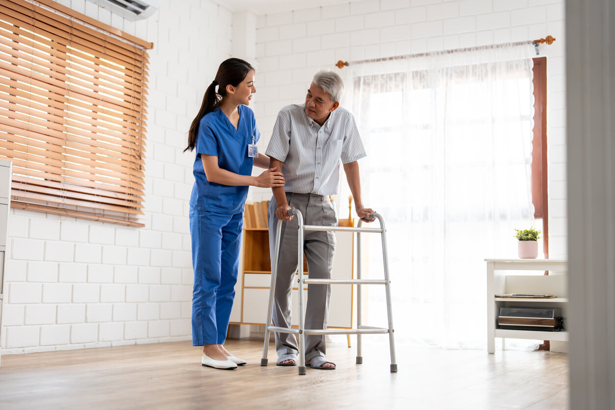 senior elderly man patient doing physical therapy with caregiver