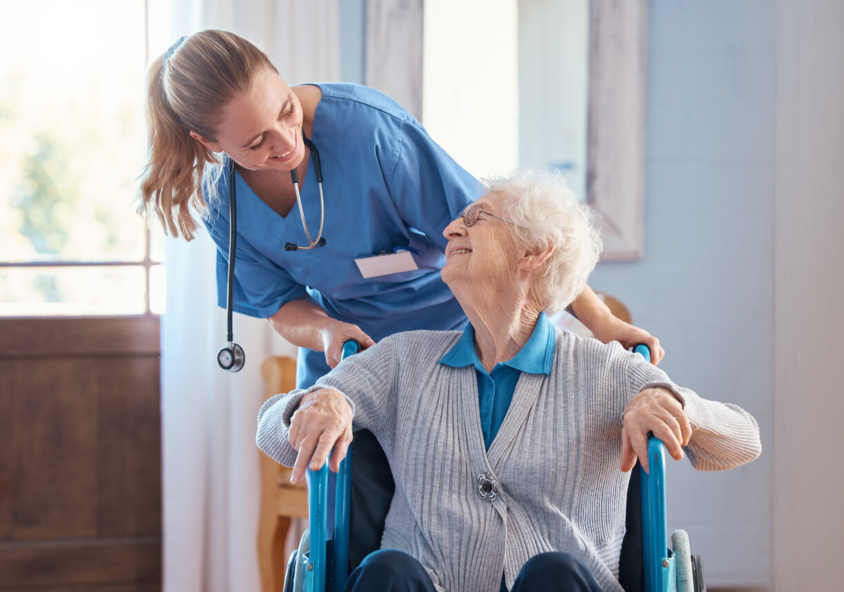Elderly woman with a disability in a wheelchair in medical nursing facility.